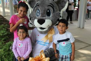 Gigi and her family post university's mascot