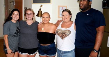 A cancer patient surrounded by her family and friends