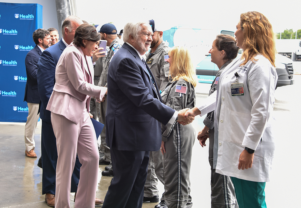 Leadership shaking hands with pilots and nurses