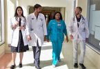 Four medical employees walking in hallway