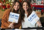 Two women holding signs