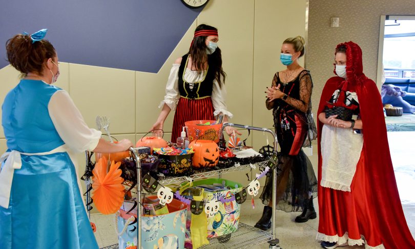 People in costume with decorated cart