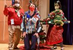 Three people in holiday sweaters