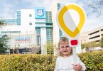 Little girl holding paper balloon