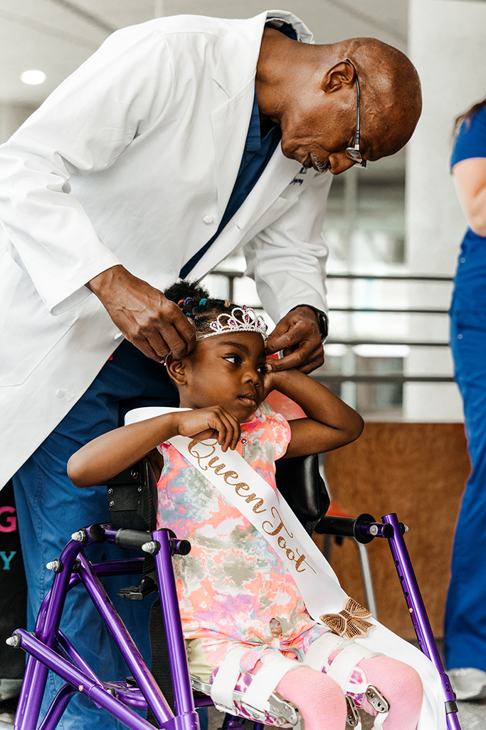Doctor putting crown on little girl