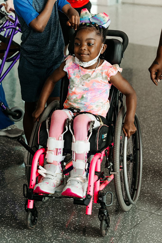 Little girl in pink in wheelchair