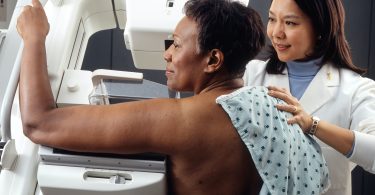 Woman receiving mammogram