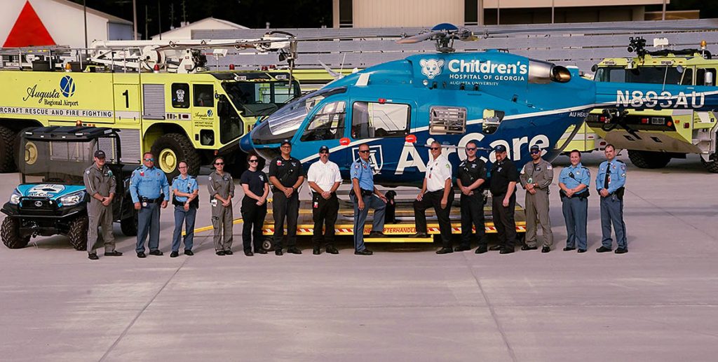 Full AirCare team in front of helicopter