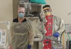 Two respiratory therapists with ECMO machine