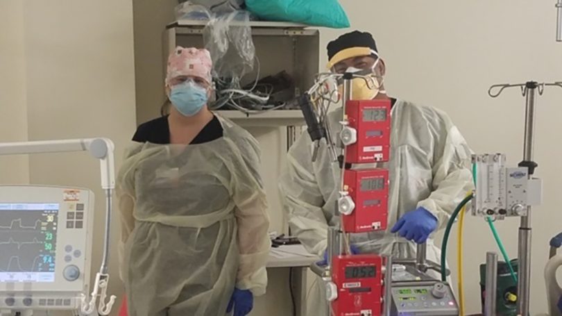 Two respiratory therapists with ECMO machine