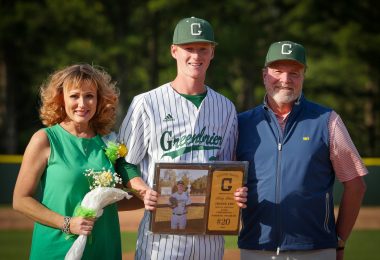 Baseball player with parents on either side