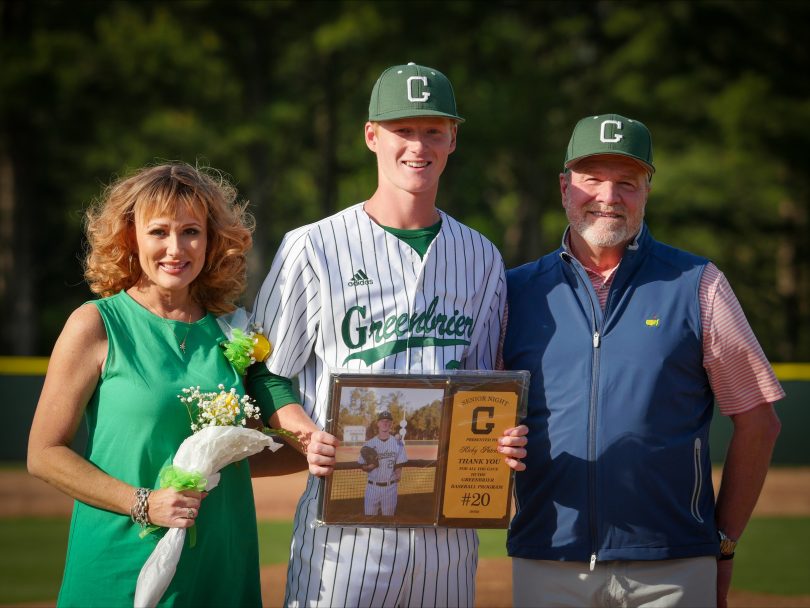 Baseball player with parents on either side