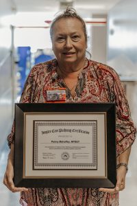 Woman holding framed certificate