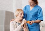 Nurse giving patient medicine