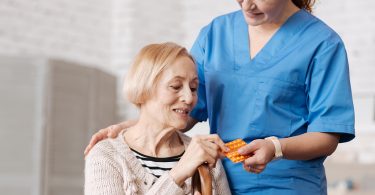 Nurse giving patient medicine
