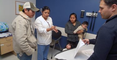 Hispanic family with doctor and interpreter