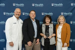 Four people with award