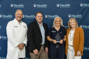 Four people with award