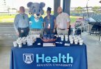 Roary at AU Health table with three other people