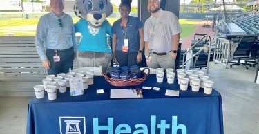 Roary at AU Health table with three other people