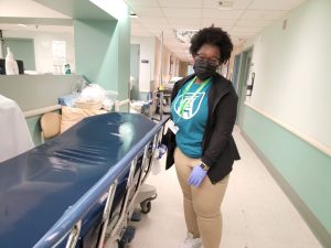 Volunteer wipes down beds