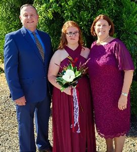 Family of three posing for photo