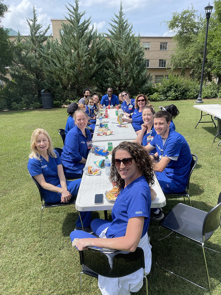 Long table of nurses on the lawn