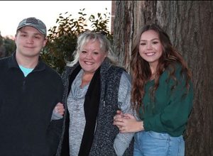 Three people pose for photo