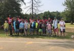 Football players with boy campers
