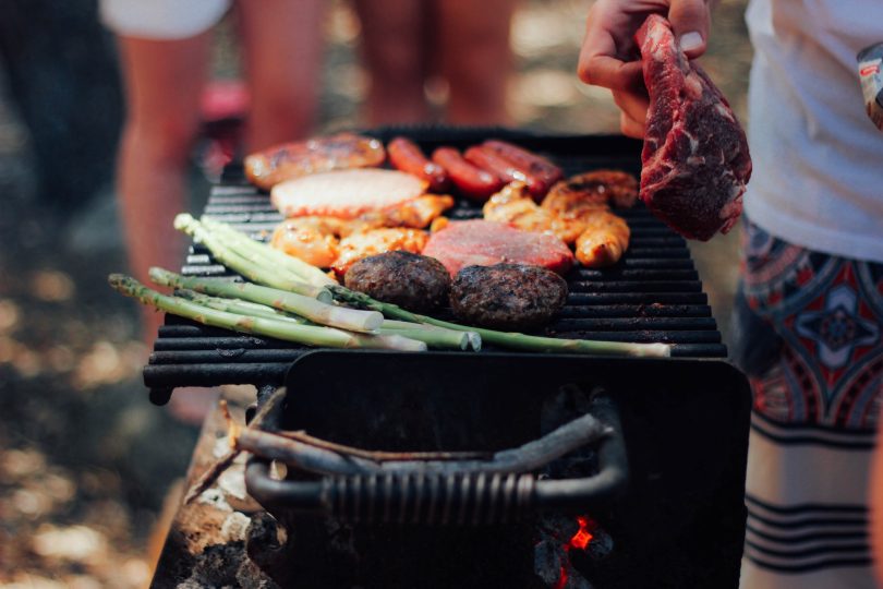 Person grilling meat photo