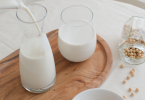 Milk pouring and soy beans on a table