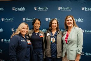 Honorees pose while serving food at the Wellstar MCG Health all-star breakfast