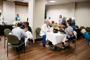 Attendees eat at tables at the Wellstar MCG Health all-star breakfast