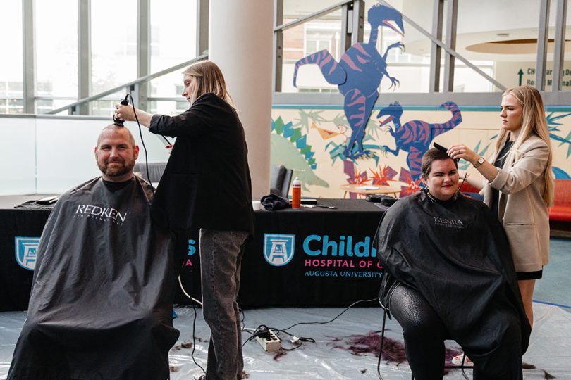 Man and woman getting heads shaved
