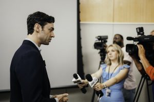 Man talking to reporters