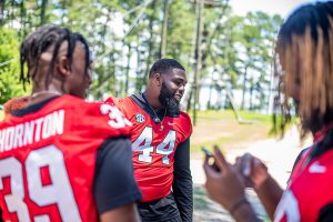 Man in football jersey smiling