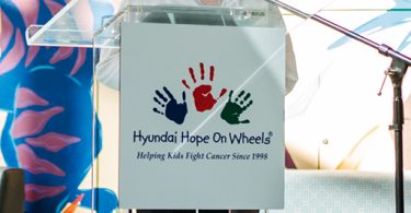 Teen cancer patient speaks at podium