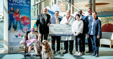 Group of people holding a check